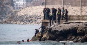 Read more about the article Thousands of people break through border separating Morocco from Spain’s Ceuta