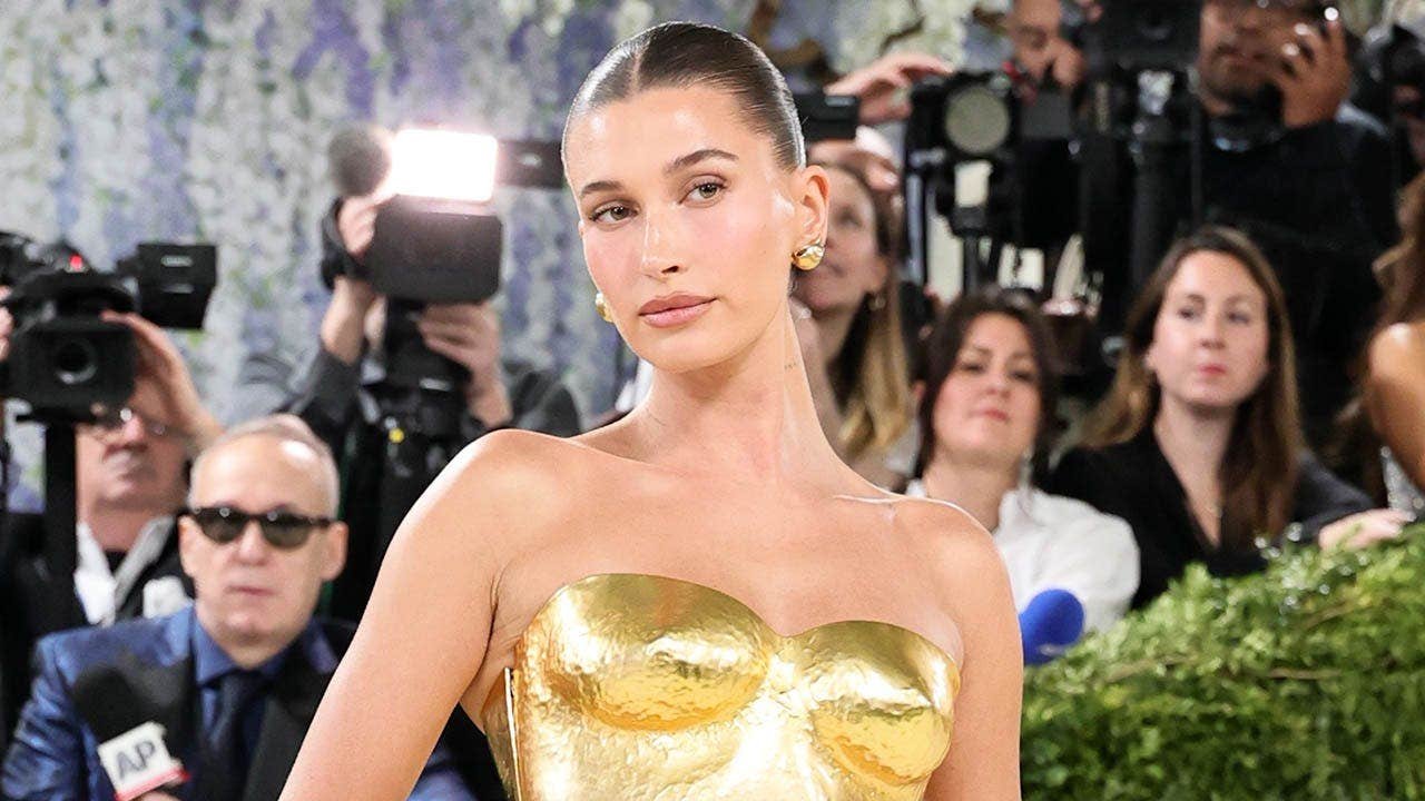 You are currently viewing Hailey Bieber poses in yellow bikini and Rhode eye patches on Instagram