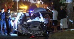 Read more about the article Driver fleeing police smashes into parked cars, shearing roof off a vehicle